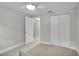 This bedroom features a ceiling fan, closet, and neutral carpeting and paint at 3721 Casaba Loop, Valrico, FL 33596