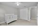 Bedroom showcasing a crib, neutral colors, and closet, providing a cozy and calming environment at 3721 Casaba Loop, Valrico, FL 33596
