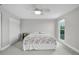 Bright, carpeted bedroom with ceiling fan, closet, and window overlooking the yard at 3721 Casaba Loop, Valrico, FL 33596