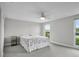 Bright, carpeted bedroom with ceiling fan and large windows with outdoor views at 3721 Casaba Loop, Valrico, FL 33596