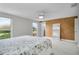 Bright bedroom with ceiling fan, windows, carpet, and cork accent wall at 3721 Casaba Loop, Valrico, FL 33596