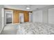 Bright bedroom with ceiling fan, cork accent wall, closet, and en-suite bathroom at 3721 Casaba Loop, Valrico, FL 33596