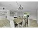 Dining area with modern chandelier and a view into the kitchen, creating a perfect space for Gathering gatherings at 3721 Casaba Loop, Valrico, FL 33596