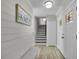 Inviting entryway with staircase, decorative shiplap, and stained glass in the front doors at 3721 Casaba Loop, Valrico, FL 33596