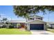 Charming two-story home with a well-manicured lawn and inviting red double-door entrance, creating a welcoming curb appeal at 3721 Casaba Loop, Valrico, FL 33596