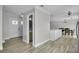 Bright foyer with stylish flooring, powder room, and a view of the dining room at 3721 Casaba Loop, Valrico, FL 33596