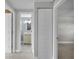 Hallway with neutral carpet leading to bathroom and bedroom, doors open to multiple rooms at 3721 Casaba Loop, Valrico, FL 33596