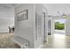 Hallway with beachy decor including a 'Gathering' sign and access to the pool area at 3721 Casaba Loop, Valrico, FL 33596