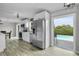 Well-equipped kitchen with stainless steel appliances and sleek cabinetry, adjacent to an outdoor pool area at 3721 Casaba Loop, Valrico, FL 33596