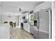 Bright kitchen with stainless steel appliances, white cabinets, and an adjacent dining area at 3721 Casaba Loop, Valrico, FL 33596
