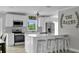 Bright kitchen featuring white cabinetry, stainless steel appliances, and a large island with bar seating at 3721 Casaba Loop, Valrico, FL 33596