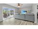 Comfortable living room features a large gray couch and sliding doors to patio area at 3721 Casaba Loop, Valrico, FL 33596