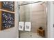 Tiled shower in bathroom with glass door and matching towels and decor at 3877 Consolare Ct, Wesley Chapel, FL 33543