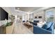 Open-concept living room with recessed lights, luxury vinyl flooring, and comfortable seating arrangement at 3877 Consolare Ct, Wesley Chapel, FL 33543