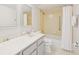 Well-maintained bathroom with tile shower, sink vanity, and mirrored cabinet at 400 64Th Ave # 202, St Pete Beach, FL 33706
