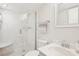 Bright bathroom showcasing a glass-enclosed shower, updated vanity, and classic fixtures at 400 64Th Ave # 202, St Pete Beach, FL 33706