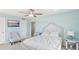 This bedroom features soothing light blue walls, a comfortable bed, and stylish ceiling fan at 400 64Th Ave # 202, St Pete Beach, FL 33706