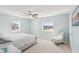 Bedroom featuring carpet floor, ceiling fan, two large windows and modern furniture at 400 64Th Ave # 202, St Pete Beach, FL 33706