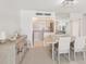 Open-concept dining room flowing into kitchen, plenty of light and seating at 400 64Th Ave # 202, St Pete Beach, FL 33706