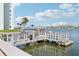 View of a shared dock with boats in the water on a sunny day with a blue sky and scattered white clouds at 400 64Th Ave # 202, St Pete Beach, FL 33706