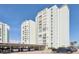View of the building's exterior, with multiple floors and parking underneath at 400 64Th Ave # 202, St Pete Beach, FL 33706