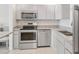 Well-lit kitchen featuring modern stainless steel appliances and ample counter space at 400 64Th Ave # 202, St Pete Beach, FL 33706