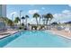 View of pristine pool featuring poolside seating and palm trees at 400 64Th Ave # 202, St Pete Beach, FL 33706