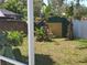 Backyard with a shed, tropical plants and a white fence at 4707 Barrett Ct, Tampa, FL 33617