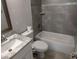 Modern bathroom featuring a tub, toilet, and vanity with marble countertop and grey tile backsplash at 4707 Barrett Ct, Tampa, FL 33617