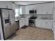 Bright kitchen featuring white cabinets, stainless steel appliances, and marble countertops at 4707 Barrett Ct, Tampa, FL 33617