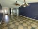 Open-concept living room featuring a unique tiled floor, ceiling fan and ample natural light at 4707 Barrett Ct, Tampa, FL 33617