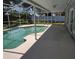 In-ground pool with screened enclosure and spacious deck for entertaining at 4707 Barrett Ct, Tampa, FL 33617