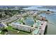 Beautiful aerial view of waterfront condos and a peaceful lake, surrounded by lush green landscaping and clear blue waters at 4775 Cove Cir # 803, St Petersburg, FL 33708
