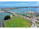Scenic aerial view featuring a waterway, bridge, and green field under a bright blue sky, offering stunning views at 4775 Cove Cir # 803, St Petersburg, FL 33708