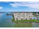 An aerial view of a condo building on a peninsula with boat docks and lush landscaping at 4775 Cove Cir # 803, St Petersburg, FL 33708