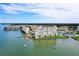 An aerial shot of waterfront condo buildings with lush landscaping and boat docks and slips at 4775 Cove Cir # 803, St Petersburg, FL 33708