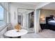 Balcony with table, and a sliding mirror door offering views into the main bedroom at 4775 Cove Cir # 803, St Petersburg, FL 33708