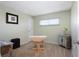 Bedroom with neutral paint, carpet, and table with a window letting in natural light at 4775 Cove Cir # 803, St Petersburg, FL 33708