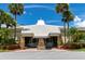 Inviting entrance with stone accents, seating, and lush landscaping at 4775 Cove Cir # 803, St Petersburg, FL 33708