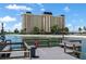 Waterfront condo building with a pier and scenic water views on a bright, sunny day at 4775 Cove Cir # 803, St Petersburg, FL 33708