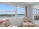 Cozy seating area offers stunning water views from the large window, perfect for relaxation at 4775 Cove Cir # 803, St Petersburg, FL 33708