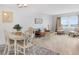 Inviting living room area with comfortable seating and a lovely view from the large window at 4775 Cove Cir # 803, St Petersburg, FL 33708