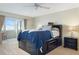 Main bedroom with dark wood furniture, soft lighting, and balcony access at 4775 Cove Cir # 803, St Petersburg, FL 33708