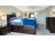 Spacious main bedroom with dark wood furniture, soft lighting, and plush bedding at 4775 Cove Cir # 803, St Petersburg, FL 33708