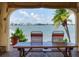 Charming waterfront view from outdoor seating area, complemented by comfortable seating and scenic vistas at 4775 Cove Cir # 803, St Petersburg, FL 33708