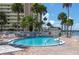Inviting pool with lounge chairs perfect for relaxation under the sun with waterfront views at 4775 Cove Cir # 803, St Petersburg, FL 33708