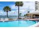 Refreshing pool overlooking the waterfront, surrounded by palm trees, promising a relaxing and tropical outdoor experience at 4775 Cove Cir # 803, St Petersburg, FL 33708