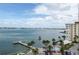 Scenic water view from the condo balcony, overlooking the pool, docks, and lush landscaping at 4775 Cove Cir # 803, St Petersburg, FL 33708