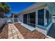 Backyard of home featuring a brick patio and sliding glass doors at 4849 Floramar Ter, New Port Richey, FL 34652