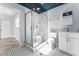 Bathroom featuring modern black and white tile, a glass enclosed shower, vanity and toilet at 4849 Floramar Ter, New Port Richey, FL 34652